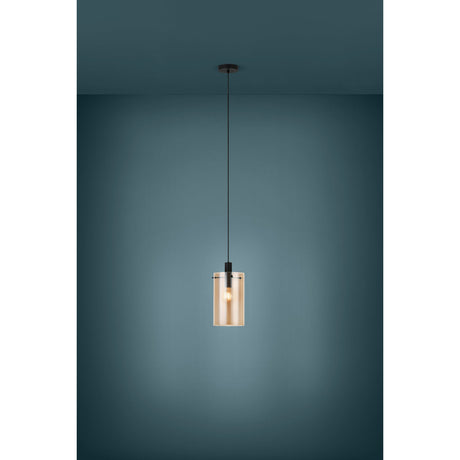 Polverara Amber Glass Pendant Light in Black, cylindrical ribbed amber glass shade on a black cord and ceiling canopy, shown lit against a dark teal background.