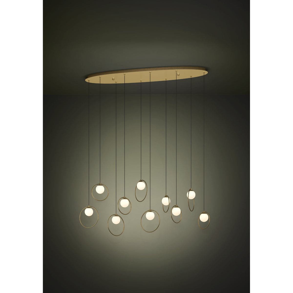Portocolom Glass 10 Light Linear Pendant Light in brass and gold, with opal glass globes in slim gold rings hanging at varied heights from a long oval canopy.