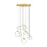 Portocolom 10 light cluster pendant with round brass ceiling plate, black cords and gold rings holding opal glass globes at staggered heights, on a white background.