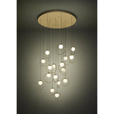Portocolom Glass 17 Light Pendant in brass and gold, with opal glass globes in slim gold rings suspended at varied heights from a round brass canopy, shown against a dark neutral background.