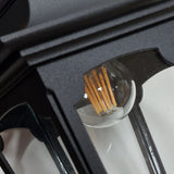 Here's a rephrased version using the product data:

Get an up-close look at the Parish 1 Light Outdoor Chain Pendant in black, expertly crafted from high-quality die-cast aluminum. Its clear glass panel showcases a retro-style LED filament bulb inside, while the detailed design of the frame enhances the modern bulb's vintage appeal.