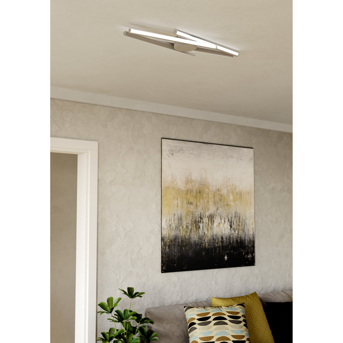Pradilla LED Flush Ceiling Light in sand finish with crossed slim bars and a round canopy, shown mounted on a living room ceiling above an abstract framed artwork.