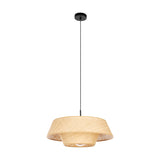 Prenvanne Pendant Light in black, featuring a two-tier woven bast shade in natural straw tone, suspended from a black steel ceiling canopy and slim cable, shown on a plain white background.