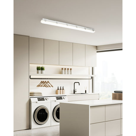 Prime LED Flush Ceiling Light, 118.8cm long with grey plastic body and white diffuser, installed above cabinetry in a modern laundry and kitchen space.