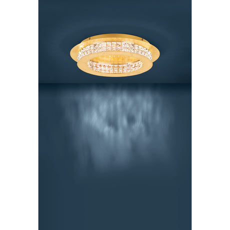 Principe LED flush ceiling light in gold-finish steel with tiered round design and square-cut crystal glass bands, mounted on a dark ceiling.