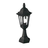 The Parish Mini 1 Light Pedestal Light in black features a vintage-style outdoor lantern design with a glass enclosure and visible bulb inside. Its hexagonal structure and pointed top enhance its charm in outdoor lighting, elegantly showcased against a white background.