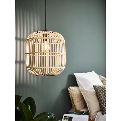 Prolbane Wooden Pendant Light 35cm in Black, a rounded cage shade of natural wood slats with black top cap and base ring, shown lit above a bedside area with cushions and a plant.