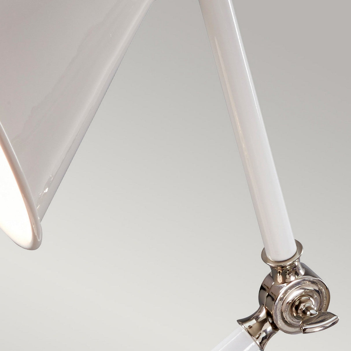 Close-up of the Provence Element 1 Light Mini Table Lamp in White and Polished Nickel against a gray background. The lamp's arm is angled to highlight its adjustable design, capturing the essence of Provence elegance with its glossy shade and polished joints.