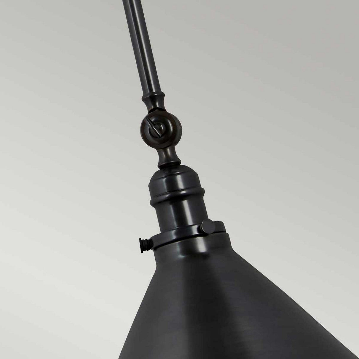 Close-up view of the Provence 1 Light Wall Light/Pendant, featuring a sleek, modern metallic design finished in old bronze. This fixture showcases a simple, angular structure with adjustable knuckle joints along its rod and a decorative joint at the top, subtly hinting at vintage French design elegance.