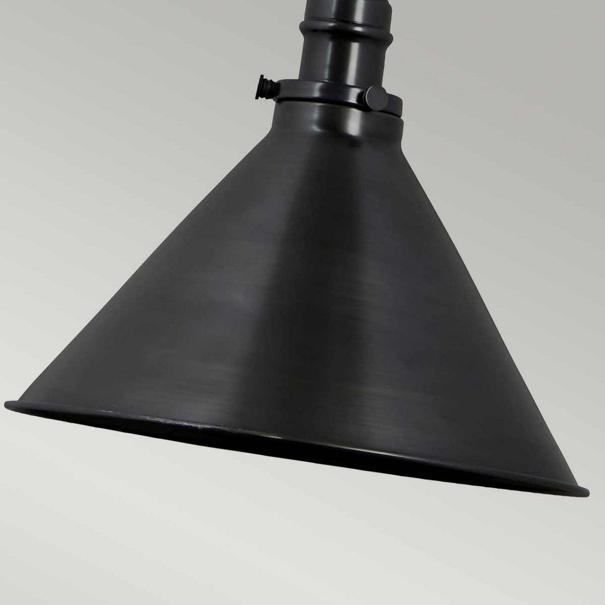 A close-up of a black, cone-shaped metal lampshade with adjustable knuckle joints against a gray background. The Provence 1 Light Wall Light/Pendant in Old Bronze features a matte finish and is elegantly attached to a cylindrical mounting bracket.