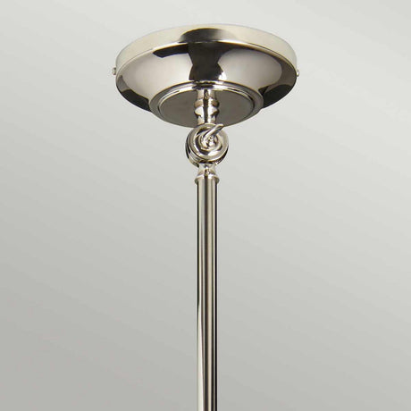 A detailed view of the Provence 1 Light Wall Light/Pendant in polished nickel showcases its metallic ceiling mount with a reflective finish. The pendant's cylindrical rod descends from the circular base, adorned with a decorative twisted design near the top. The background features a soft gradient of gray.