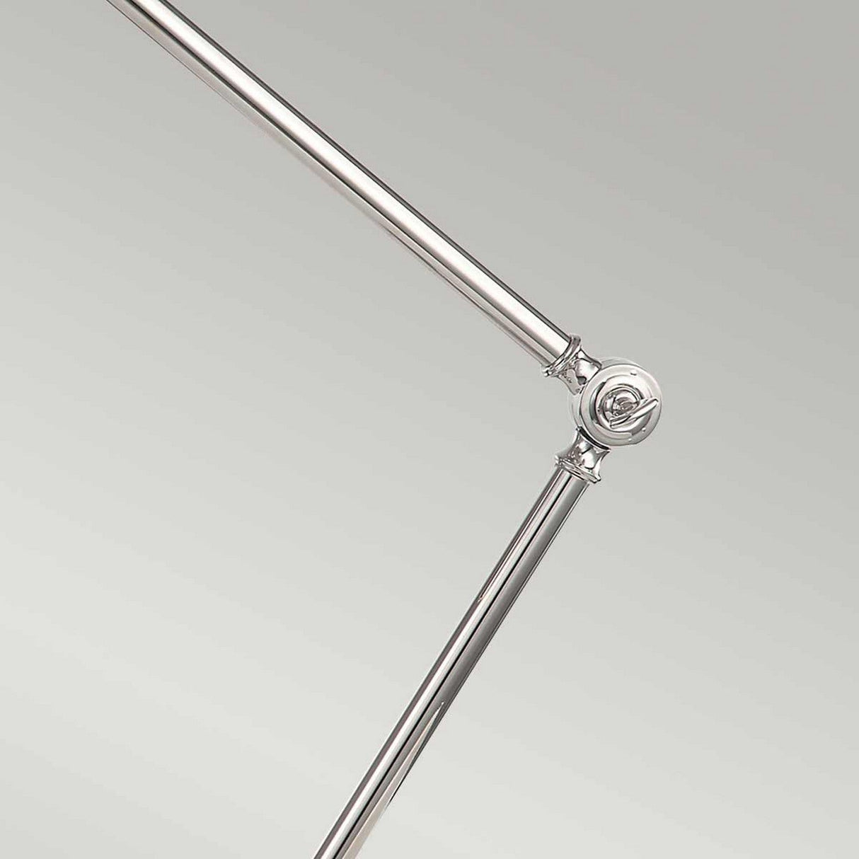 A close-up of the Provence 1 Light Table Lamp - Polished Nickel, highlighting its adjustable arm with a shiny finish and elegant hinge design against a simple, light gray background.