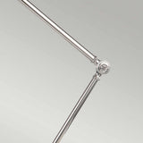 A close-up of the Provence 1 Light Table Lamp - Polished Nickel, highlighting its adjustable arm with a shiny finish and elegant hinge design against a simple, light gray background.