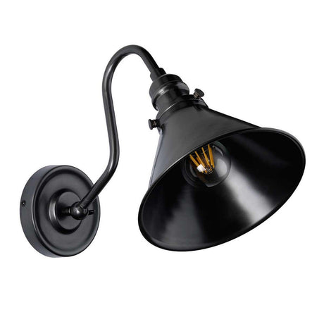 The Provence 1 Light Wall Light in Old Bronze is a black industrial-style, wall-mounted lamp with a conical shade. It features adjustable lighting and an exposed light bulb. A curved arm connects to a circular base, all finished in Old Bronze, and its matte surface enhances the lamp's modern yet vintage appearance, seamlessly blending minimalism with timeless charm.