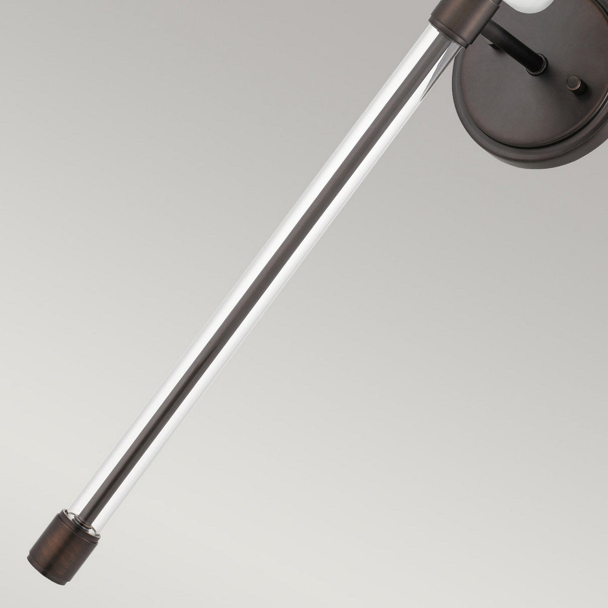 Close-up of the Barbour 1 Light Wall Light - Bronze, showcasing its modern design with a metallic extendable rod. It features a Harbor Bronze circular mount with a silver rod and darker tip, set against a light gray background, capturing sleek modern aesthetics.