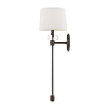 The Barbour 1 Light Wall Light - Bronze boasts a modern wall sconce design with a round white lampshade, sleek metal rod, and circular backplate. It showcases modern aesthetics with its blend of dark and light metallic finishes, including harbor bronze, providing an elegant and contemporary appeal.