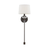 The Barbour 1 Light Wall Light - Bronze showcases a Harbor Bronze base with a long, slender metallic arm, finished with a white cylindrical lampshade. Its modern aesthetic and simple yet elegant design make it an ideal choice for contemporary interiors.