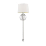 The Barbour 1 Light Wall Light in polished nickel features a contemporary design with a long, sleek metallic arm and a round backplate. This wall-mounted sconce is complemented by a simple, cylindrical white lampshade, providing elegant ambient light and serving as an ideal minimalist lighting solution for modern decor.