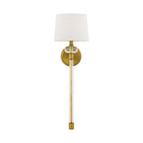 The Barbour 1 Light Wall Light - Weathered Brass is a contemporary wall sconce with vintage charm. It features a weathered brass finish and a white fabric shade, with a cylindrical clear glass rod elegantly connecting the round brass base to the shade, all set against a white background.