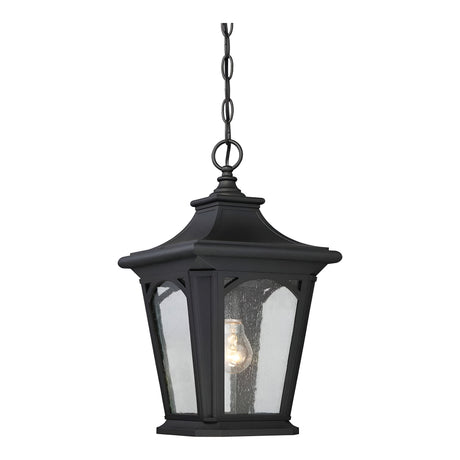 The Bedford Outdoor 1 Light Small Chain Pendant - Black boasts a sophisticated black finish with seedy glass panes, suspended gracefully from a chain. Its design allows for the light bulb to remain visible, providing an antique aesthetic while ensuring durability with its IP44 rating suitable for all weather conditions.