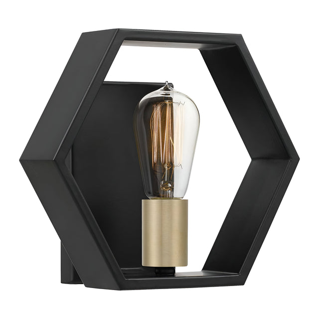 The Bismarck 1 Light Wall Light - Black showcases a striking geometric profile with a hexagonal metal frame that encases an exposed, vertically positioned vintage-style Edison bulb. The bulb is secured in a brass-colored socket with elegant gold accents.