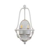 The Bradbury 2 Light Wall Light in Antique White exudes vintage charm with its dual light setup. It showcases two candle-like LED bulbs on a decorative metal frame adorned with elegant curved details and a white distressed finish.