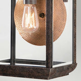 Here is a description using the given product data:

A close-up of the Byron Outdoor 1 Light Large Wall Lantern showcases its vintage-style design, featuring a square metal frame in Imperial Bronze and a clear glass panel. Inside, a glowing filament bulb is mounted against the copper reflector, creating a warm, ambient glow.