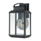 The Byron Outdoor 1 Light Medium Wall Lantern in graphite, featuring a grey reflector, boasts a modern design with clear glass panels and a visible filament bulb. This IP44 fixture includes a mounted bracket for easy attachment, enhancing the elegance of your outdoor lighting.