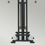 The Chastain 2 Light Tiffany Table Lamp in Vintage Bronze features a geometric design with vertical and horizontal bars on a square base. At the top, two small spheres hang gracefully. The lamp is set against a simple gray gradient background, enhancing its arts and crafts appeal.