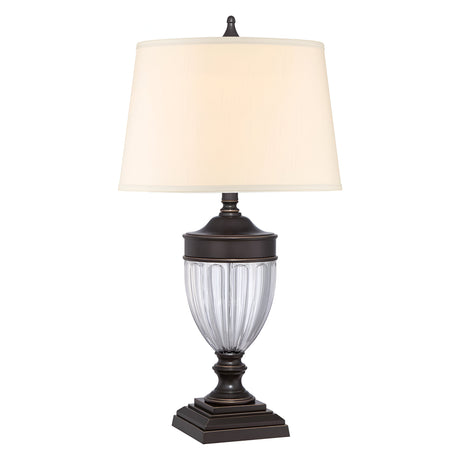 The Dennison 1 Light Table Lamp in Palladian Bronze showcases a textured glass body with a cream-colored shade, elegantly positioned on an ornate base, making it ideal for enriching Transitional Interiors.