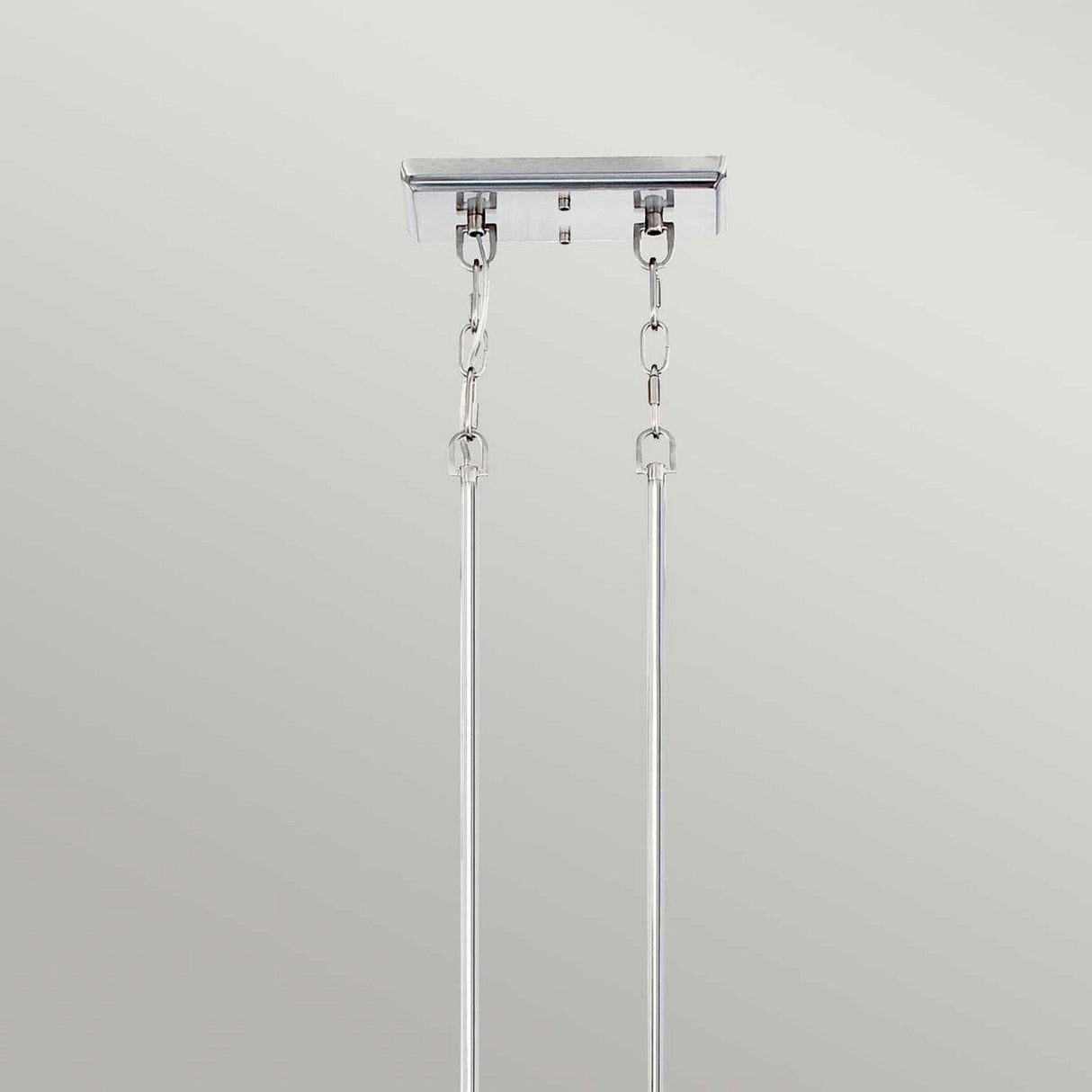 A close-up of a ceiling-mounted fixture in Imperial Silver features two chains and rods against a plain backdrop. The robust design, evoking vintage Americana, is ideal for supporting the Emery 3 Light Island Pendant or comparable hanging fixtures.