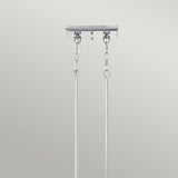 A close-up of a ceiling-mounted fixture in Imperial Silver features two chains and rods against a plain backdrop. The robust design, evoking vintage Americana, is ideal for supporting the Emery 3 Light Island Pendant or comparable hanging fixtures.