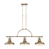 The Emery 3 Light Island Pendant - Weathered Brass is a vintage-inspired lighting fixture featuring three dome-shaped lampshades. It is suspended by two chains attached to a rectangular ceiling mount and showcases a curved arch design above the lights.