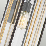 A detailed view of the Goldenrod Outdoor 1 Light Large Wall Lantern in a bronze finish showcases a vintage-style filament bulb, set within a contemporary black and gold metal frame. The IP44-rated design allows the bulb to emit a warm glow that beautifully contrasts with the sleek vertical lines of the frame, making it an ideal choice for an outdoor wall lantern.