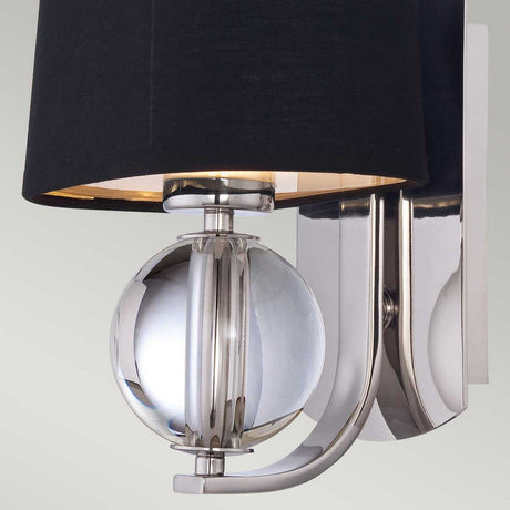 Introducing the Gotham 1 Light Wall Light - Imperial Silver: a modern decor masterpiece with an Imperial Silver finish. It features a reflective spherical accent and a black lampshade mounted on a flat vertical base.