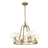 The Gotham 4 Light Chandelier in brushed brass showcases urban-inspired elegance with its circular frame and four white lampshades. Each shade is complemented by a spherical clear glass accent, and the chandelier hangs gracefully from a matching chain and ceiling mount.