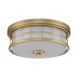 Introducing the Guardian 2 Light Flush in Painted Natural Brass: This round fixture boasts a grid-like design with frosted glass. Its central button-like detail adds a vintage-inspired touch, making it an ideal choice for bathroom lighting.