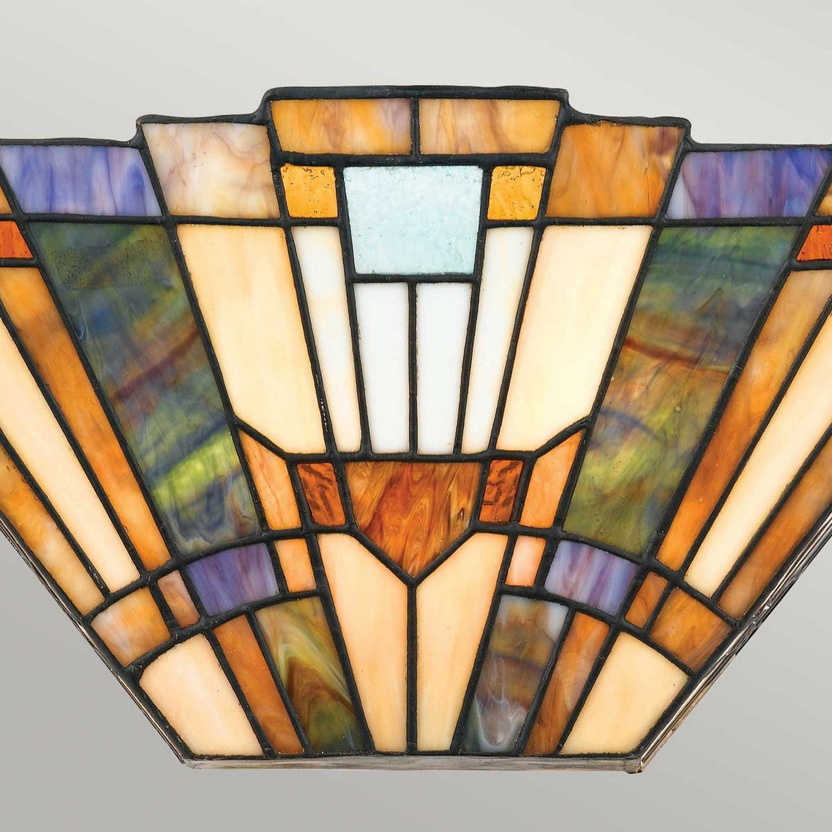 The Inglenook 2 Light Tiffany Wall Light in Valiant Bronze showcases an Art Deco stained glass lampshade with geometric patterns in vibrant hues of orange, yellow, blue, and green, reminiscent of Arts & Crafts lighting. These colors are symmetrically arranged to create a striking design.