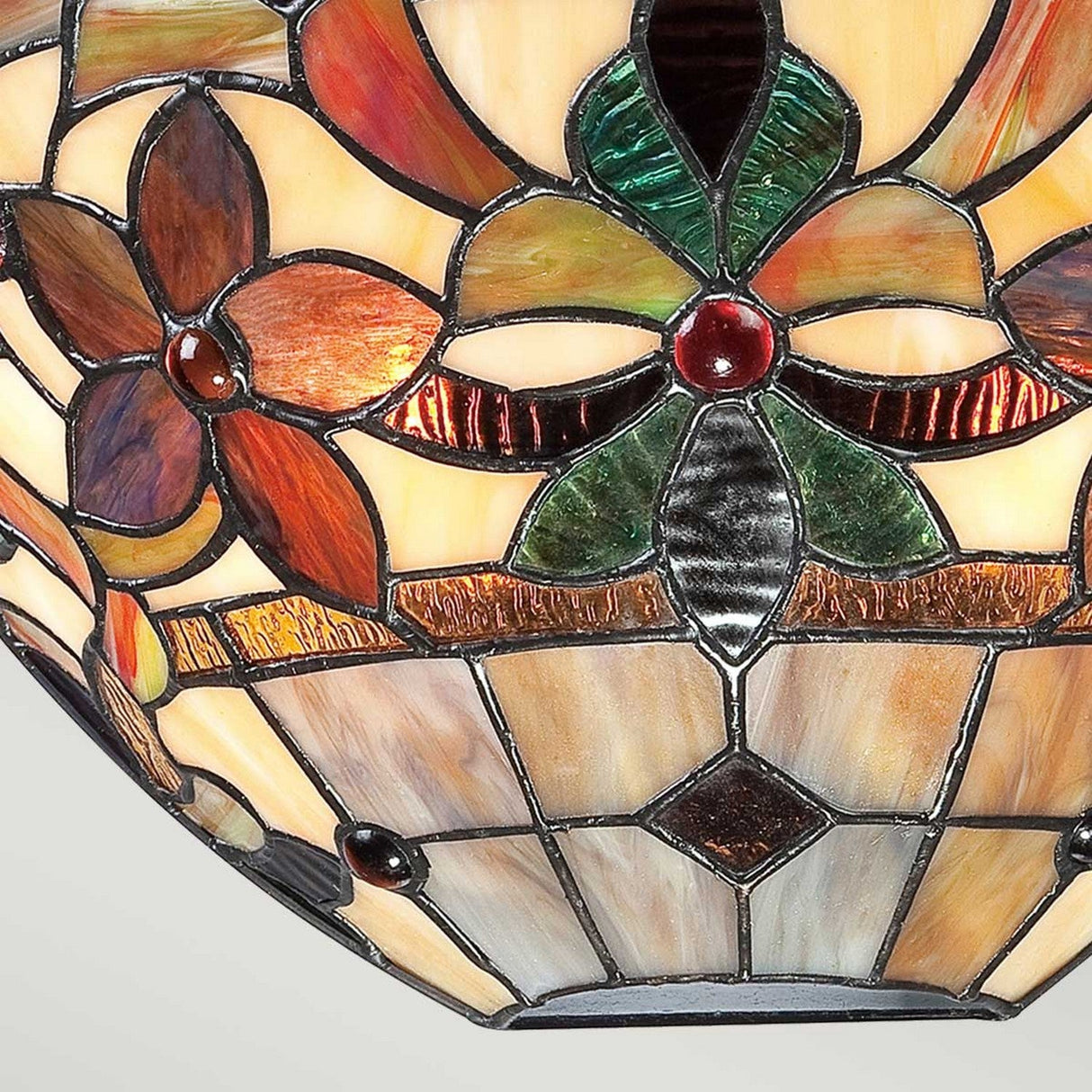 Close-up of the Kami 2 Light Tiffany Wall Light in Vintage Bronze, showcasing a stained glass lampshade adorned with a floral design of red, green, and orange petals. The intricate Art Nouveau pattern incorporates geometric shapes and textures, evoking the classic style synonymous with Tiffany lighting for a vibrant and ornamental appearance.