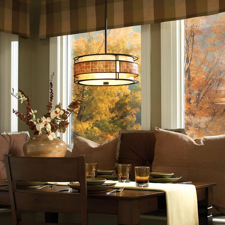 A cozy dining area with a wooden table set for four, featuring a large decorative vase and four glasses. The warm glow of the Laguna 4 Light Chandelier in Renaissance Copper hangs above. Large windows reveal a view of vivid fall foliage with orange and yellow leaves outside.