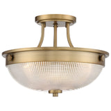 The Mantle 2 Light Semi-Flush - Weathered Brass features a round, prismatic glass shade and a weathered brass frame with a classic design, accented by a warm gold finish that enhances its elegant and timeless appeal.
