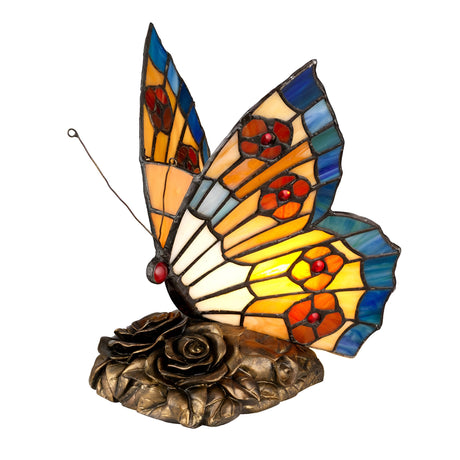 The Tiffany Animal Lamps Orange Butterfly Lamp - Architectural Bronze showcases vibrant orange, blue, and red mosaic wings that elegantly rest on a bronze flower-shaped base.