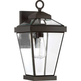 The Ravine Outdoor Medium Wall Lantern in Western Bronze showcases a classic design with beveled glass panels surrounding a single bulb. It features a decorative loop at the top and a rectangular mounting base, adding timeless elegance to any exterior.