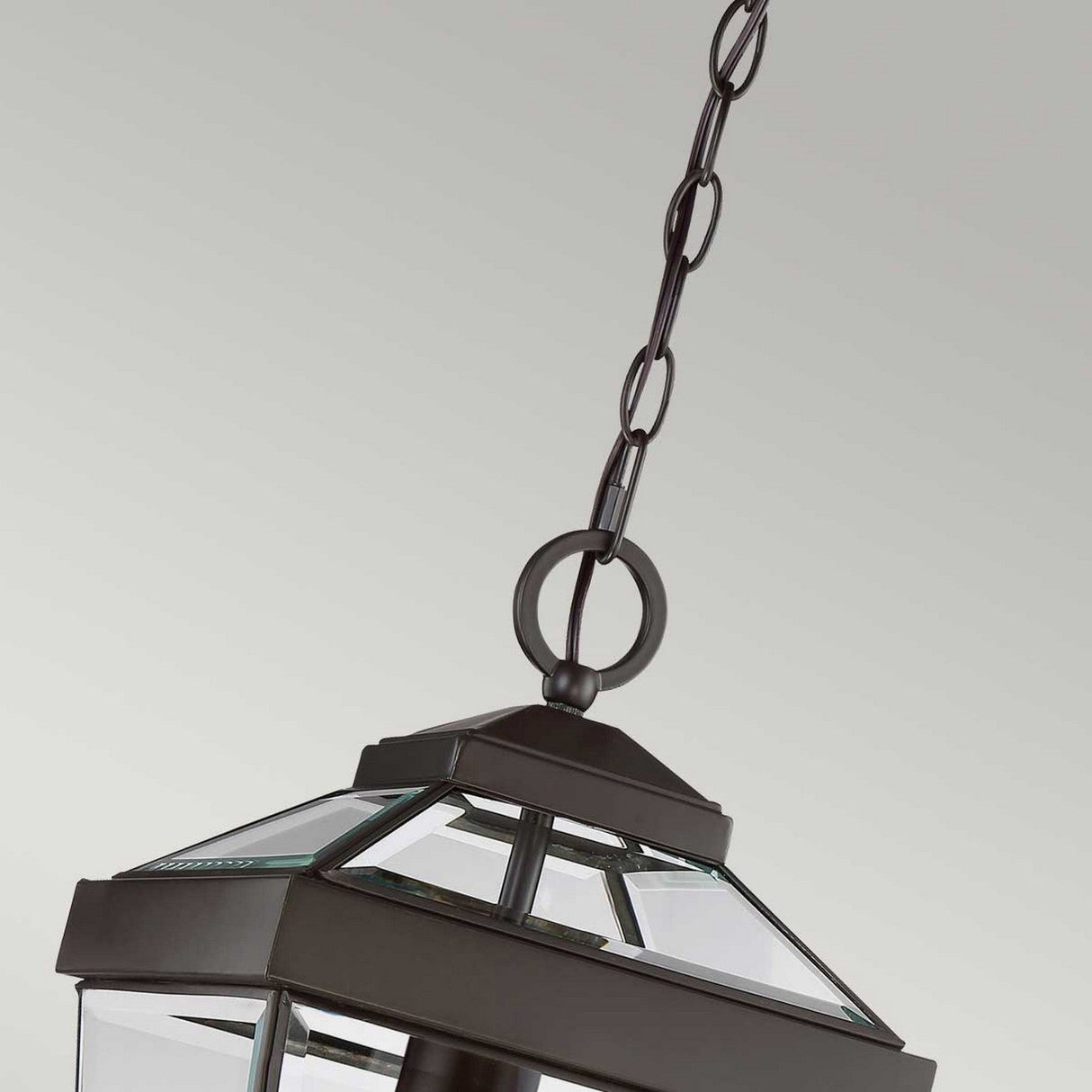 A close-up of the Ravine Outdoor Medium Chain Pendant in Western Bronze, featuring clear beveled glass panels, suspended by a black metal chain against a neutral background.