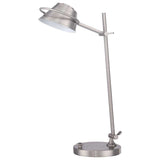 The Spencer LED Table Lamp in Brushed Nickel boasts a modern design with a round base, straight stem, and pivoting conical lampshade. It offers perfect task lighting and comes with an adjustable dimmer for customized brightness.