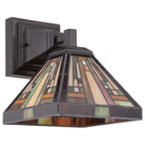 The Stephen 1 Light Tiffany Wall Light - Vintage Bronze captures the essence of the Arts & Crafts Movement with its geometric patterns in brown, beige, and green. The stained glass is beautifully encased in a vintage bronze frame that connects to a square metal mount.