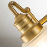 A close-up of the Swell 2 Light Wall Light in brushed brass, showcasing its modern design with a curved arm and frosted glass shade against a neutral backdrop. The fixture's elegant, smooth lines and warm gold finish provide both style and an IP44 rating for enhanced durability.