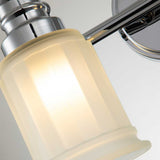 A close-up view of the Swell 2 Light Wall Light in polished chrome showcases its modern aesthetic, featuring sleek lines and a softly illuminated frosted glass shade that highlights the smooth texture of the glass and the reflective surface of the polished metal.