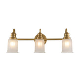 The Swell 3 Light Wall Light in brushed brass features a classic and elegant design, perfect for any sophisticated space. It includes three LED G9 bulbs with frosted glass shades, mounted on a horizontal bar that's connected to a circular wall plate.