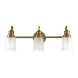 The Swell 3 Light Wall Light - Brushed Brass showcases a polished fixture with three frosted glass shades aligned in a row, each gracefully supported by a curved arm. Compatible with LED G9 bulbs, this timeless piece merges classic elegance with contemporary efficiency.